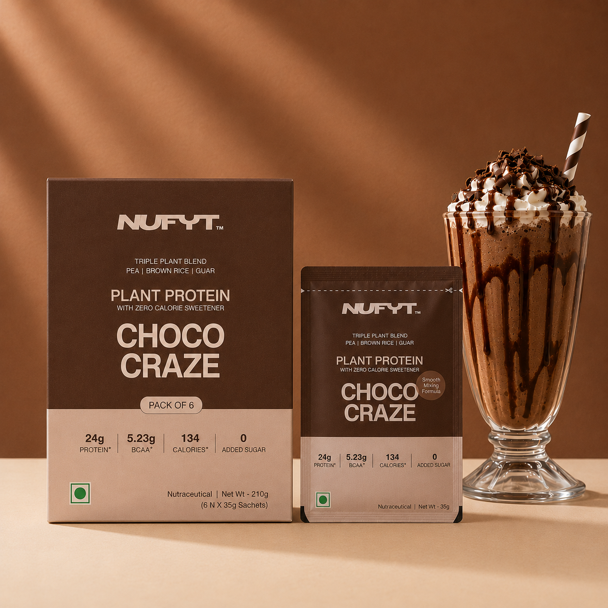 40738242265137 NUFYT Choco Craze plant protein powder packaging shown alongside a tall glass of chocolate milkshake topped with whipped cream and chocolate shavings, on a warm brown studio background.
